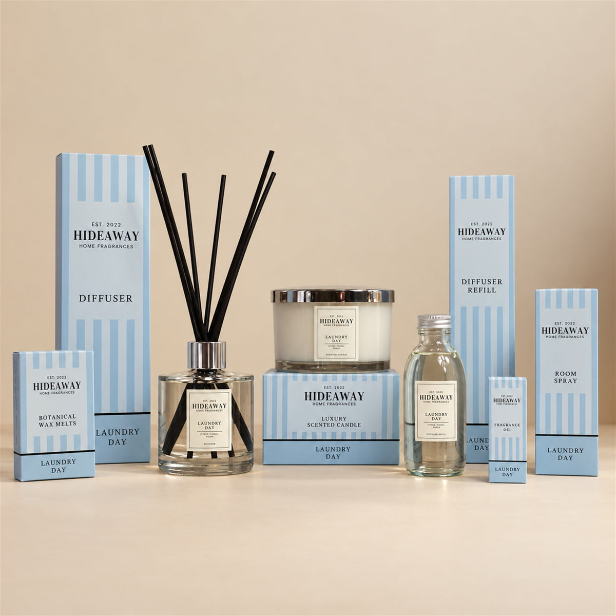 Hideaway Home Fragrances Laundry Day collection featuring 3 wick candles, reed diffusers, room sprays, and wax melts