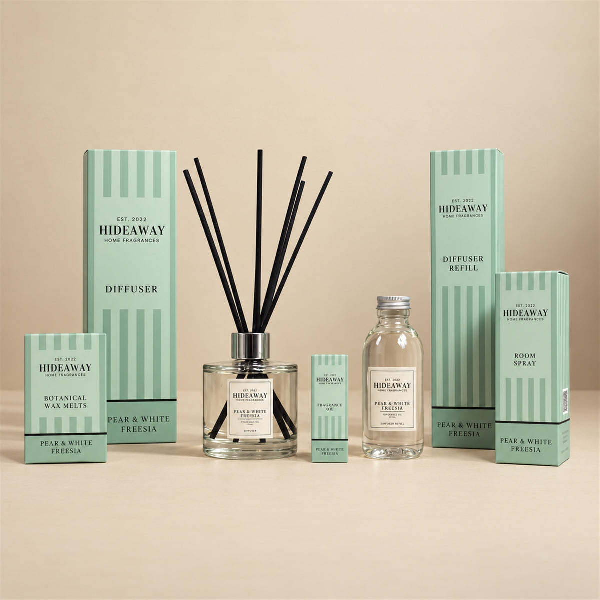Hideaway Home Fragrances pear and white freesia collection including diffusers, candles, wax melts, and sprays