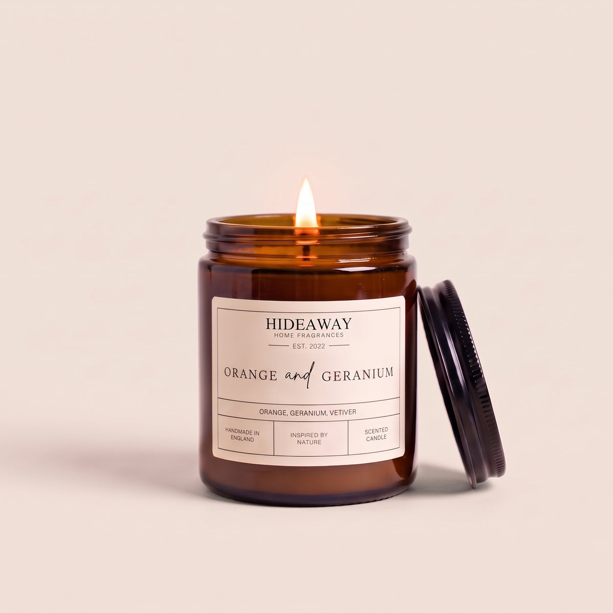 Hand-poured orange and geranium amber glass candle featuring sweet sweet orange and Egyptian geranium notes, Hideaway Home Fragrances