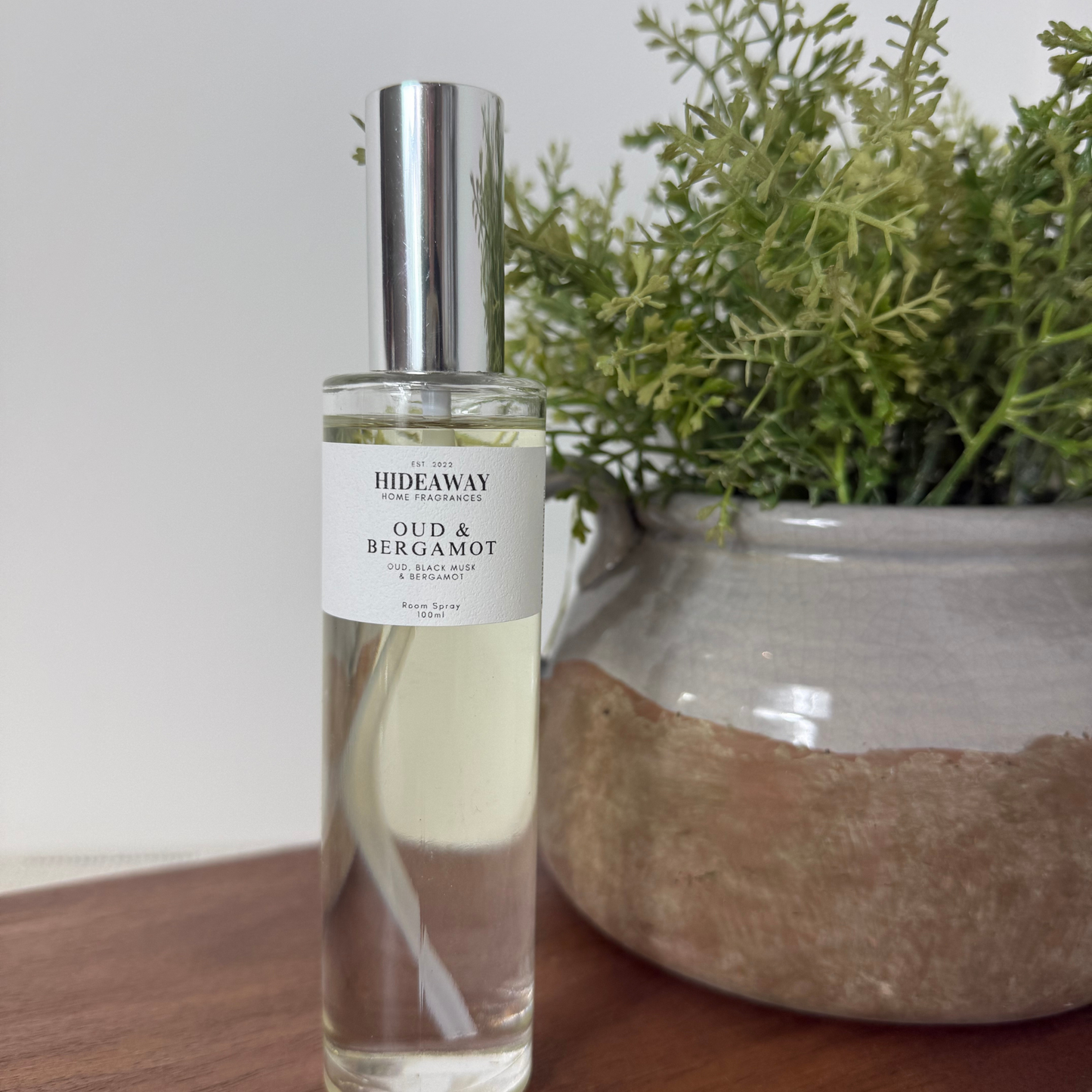 Sophisticated room spray with bold oud, zesty bergamot, and warm cinnamon base notes - Hideaway Home Fragrances