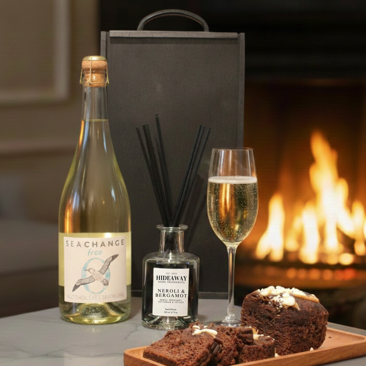 Choice of Sea Change Prosecco, Rosé, or Alcohol-Free bottles displayed next to a luxury reed diffuser.