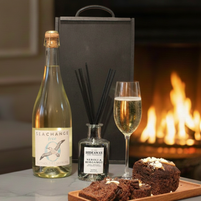 Choice of Sea Change Prosecco, Rosé, or Alcohol-Free bottles displayed next to a luxury reed diffuser.