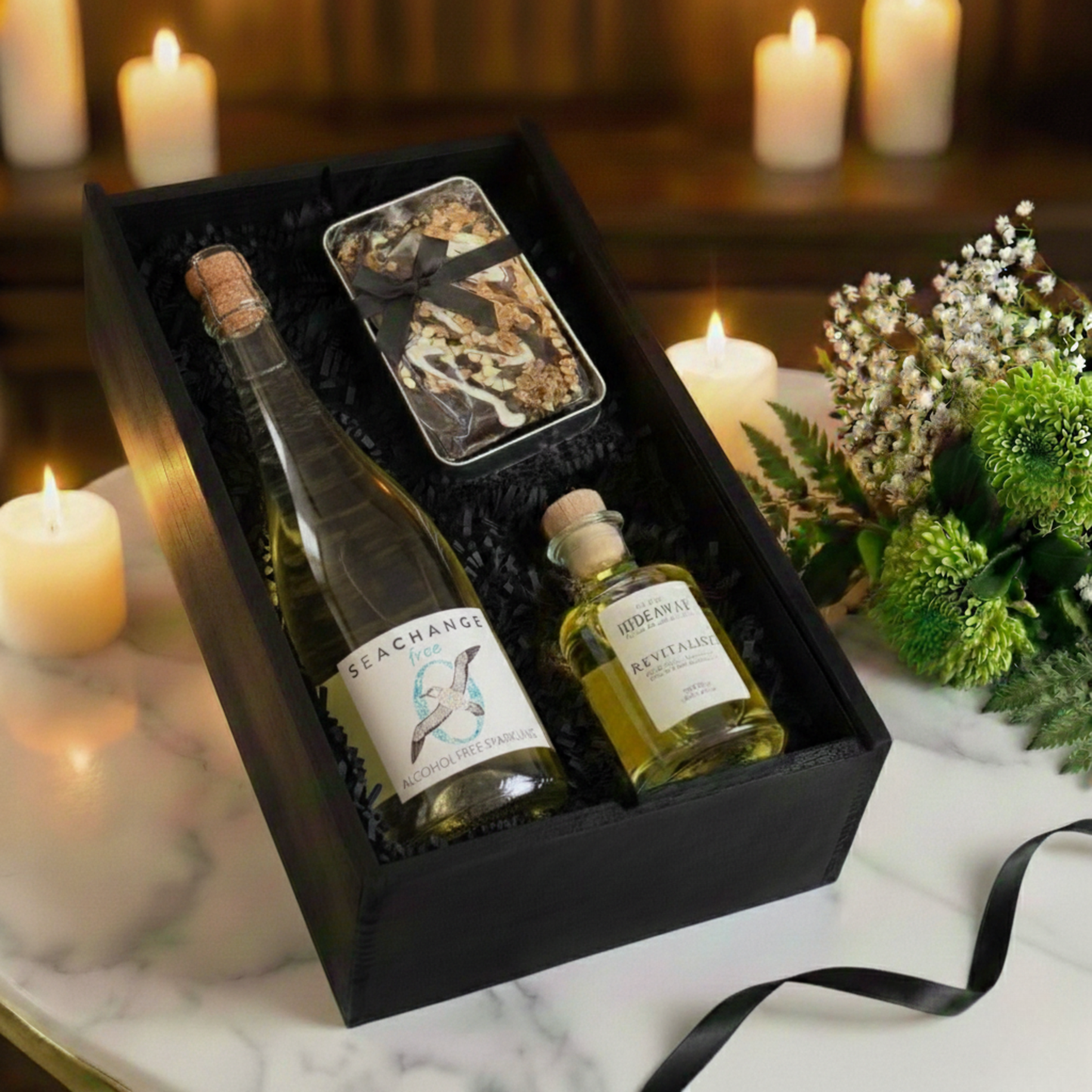 Choice of Sea Change Prosecco, Rosé, or Alcohol-Free bottles displayed next to a luxury reed diffuser.