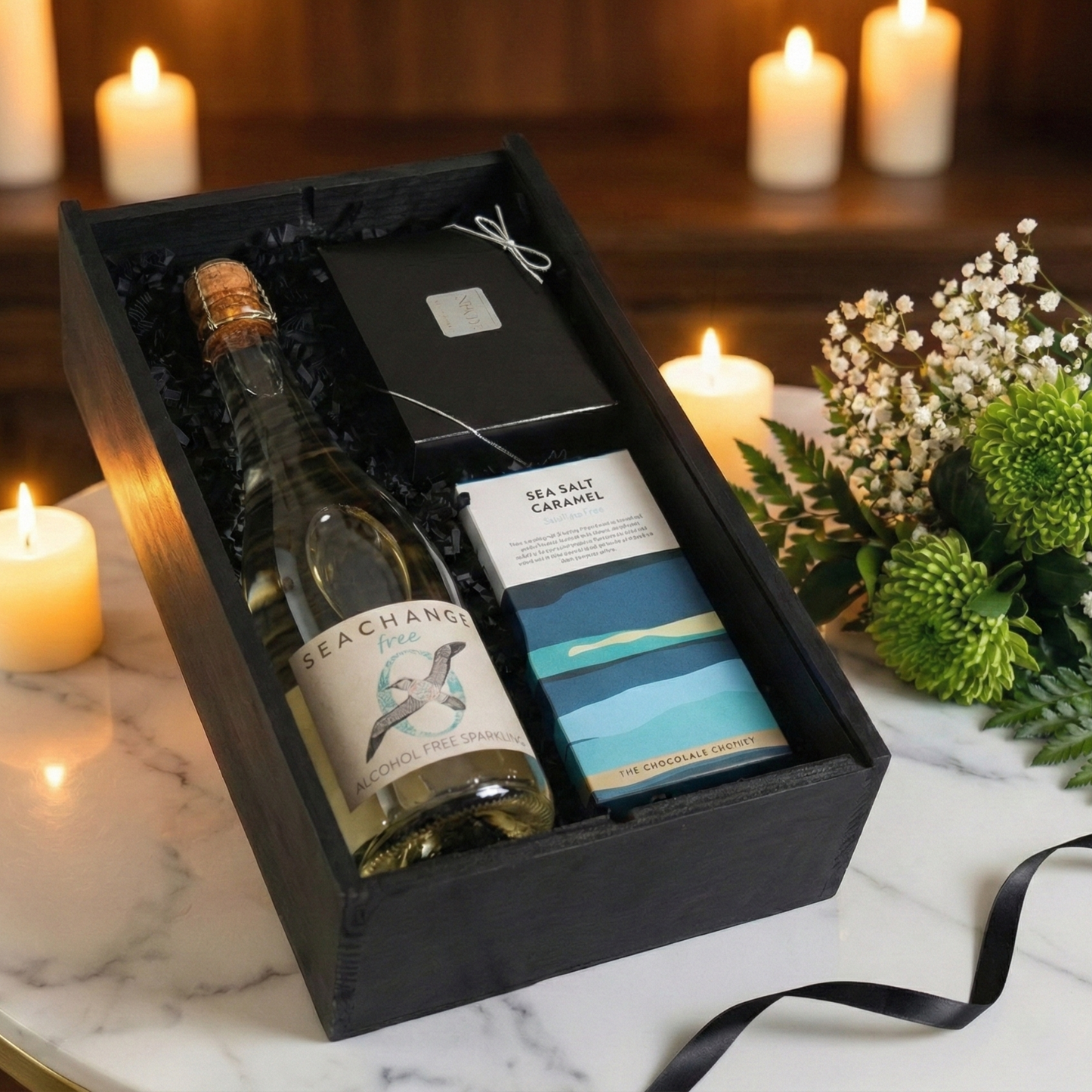 Sleek black wooden wine box slider opening to reveal eco-friendly sparkling wine and gourmet chocolates.