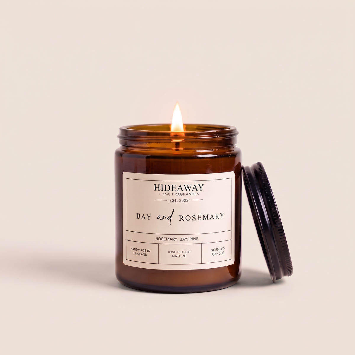 Bay and rosemary aromatherapy candle in a dark amber glass container by Hideaway Home Fragrances