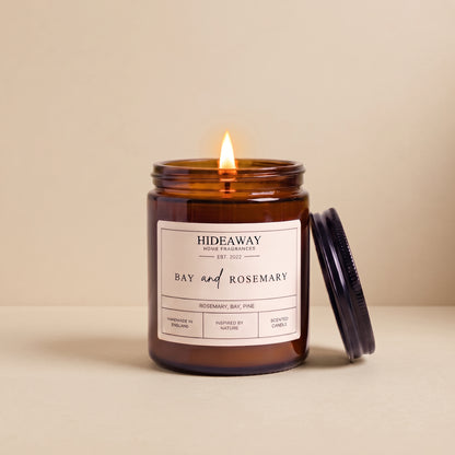 Bay and rosemary aromatherapy candle in a dark amber glass container by Hideaway Home Fragrances