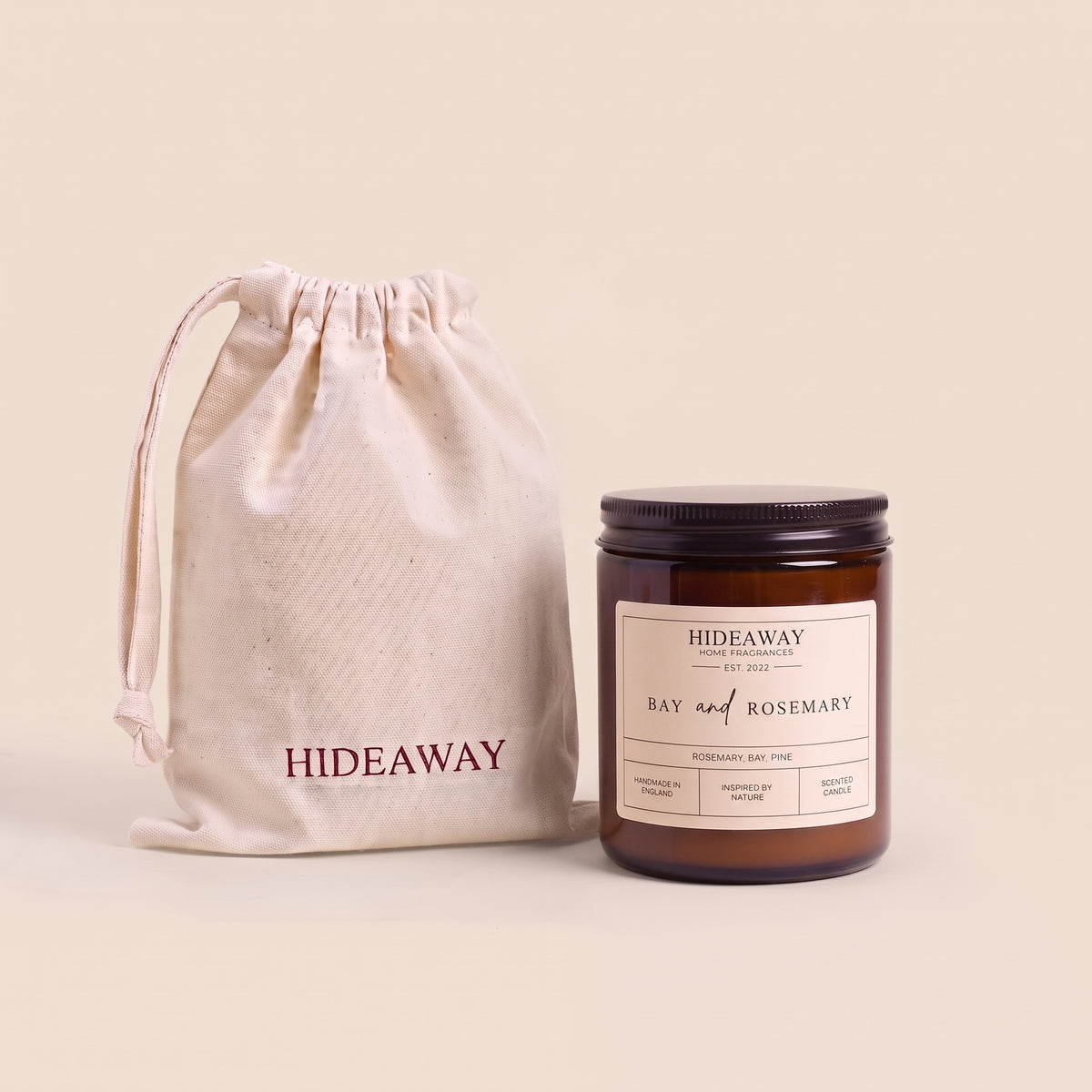Natural soy wax candle with botanical bay leaf and fresh rosemary fragrance in reusable amber glass by Hideaway Home Fragrances