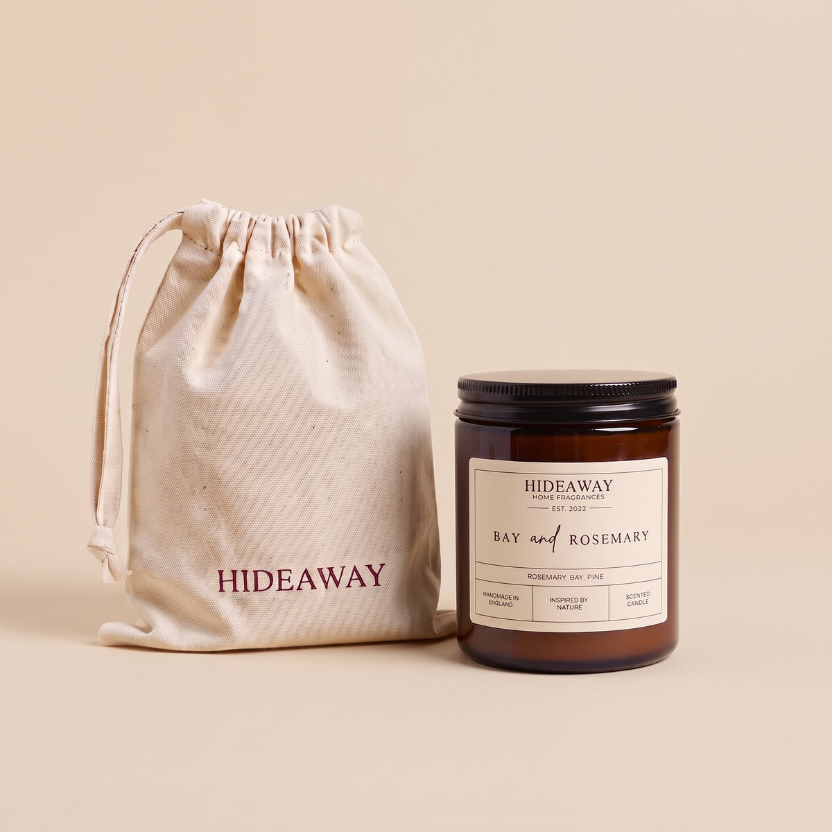Natural soy wax candle with botanical bay leaf and fresh rosemary fragrance in reusable amber glass by Hideaway Home Fragrances