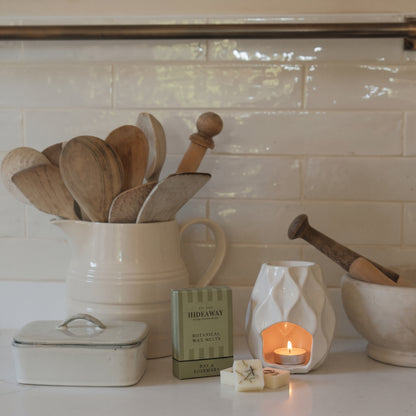 Handcrafted botanical wax melts by Hideaway Home Fragrances featuring dried rosemary and herbal bay leaf accents