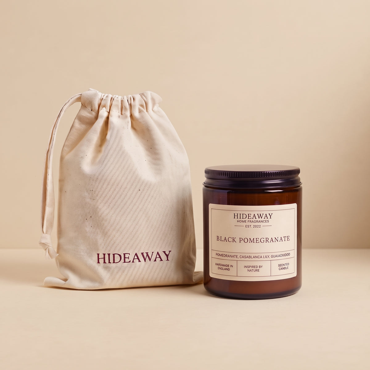 Natural soy wax candle with rich black pomegranate fragrance in reusable amber glass by Hideaway Home Fragrances