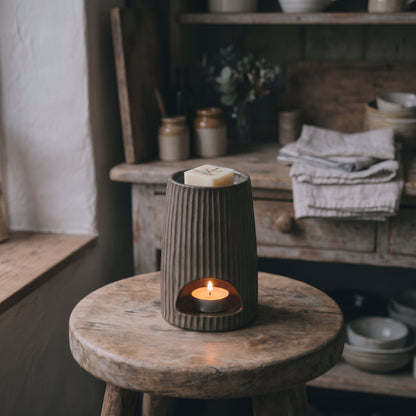 Bronze Ribbed Ceramic Wax Melt Burner with a glossy glaze finish, textured ribbing, and open back for tea lights by Hideaway Home Fragrances, shown on a neutral background.