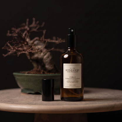Fragrance notes breakdown for Hideaway Home Fragrances cuban tobacco and oak room spray with mint, cognac, smoky incense, and warm oak.