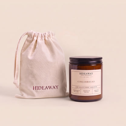 Holiday gingerbread amber glass candle emitting a warm glow for seasonal cosy decor from Hideaway Home Fragrances
