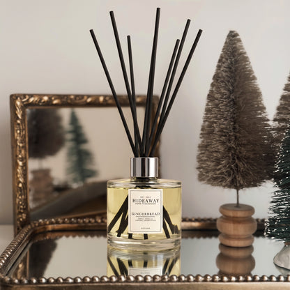 Hideaway Home Fragrances gingerbread reed diffuser bottle with natural fibre
 reeds on a shelf