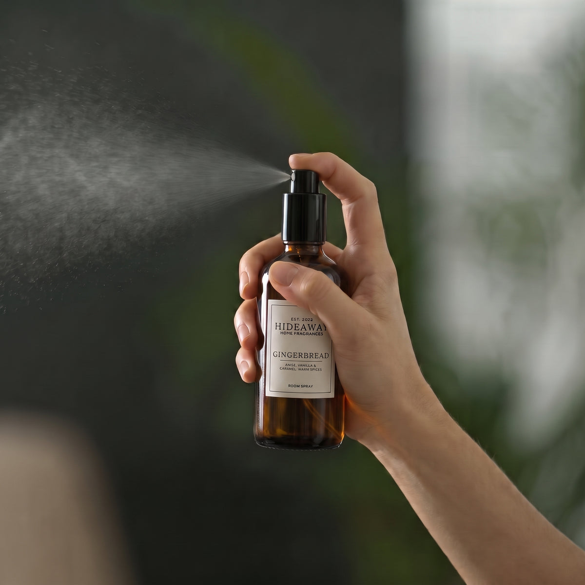 Close-up view of the label and fine mist atomiser on the Hideaway Home Fragrances gingerbread room spray bottle.