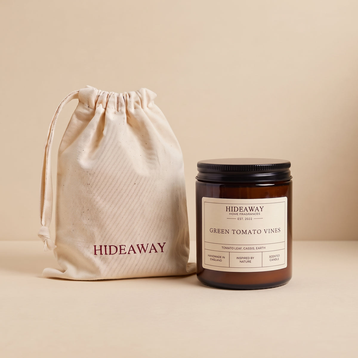 Earthy green tomato vines aromatic candle in an amber glass jar creating a fresh garden mood from Hideaway Home Fragrances