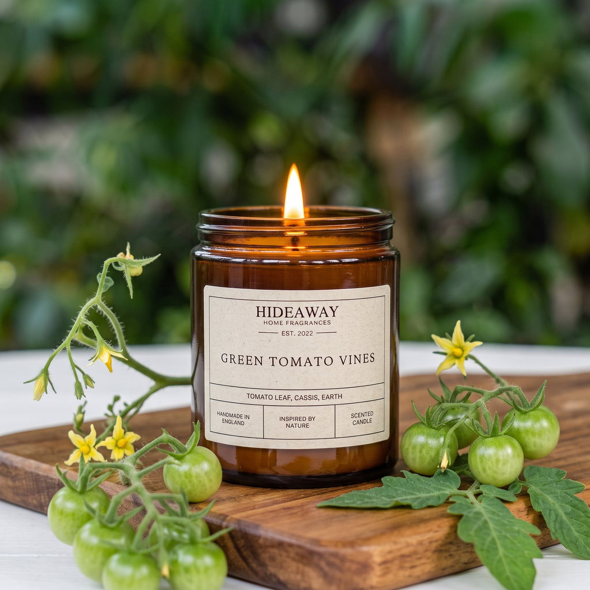 Fresh green tomato vines amber glass jar candle styled on a sunny kitchen windowsill, Hideaway Home Fragrances
