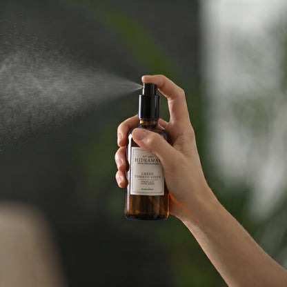Close-up of the label and spray nozzle on the Hideaway Home Fragrances green tomato vines room spray bottle.