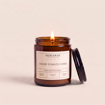 Hand-poured green tomato vines amber glass candle featuring crisp notes of crushed tomato leaves and herbal greens, Hideaway Home Fragrances