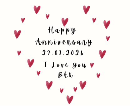 Close up of personalised love heart anniversary candle with custom date next to a matching reed diffuser