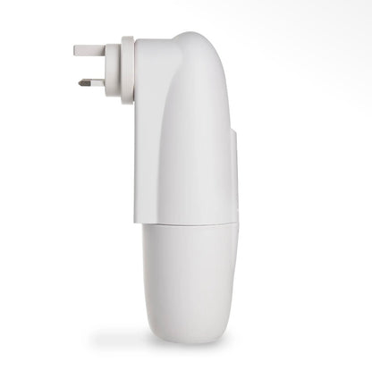 A hand plugging the compact Kapplico Waterless Plug-In Diffuser by Hideaway Home Fragrances into a bedroom outlet, showcasing its small, space-saving size.