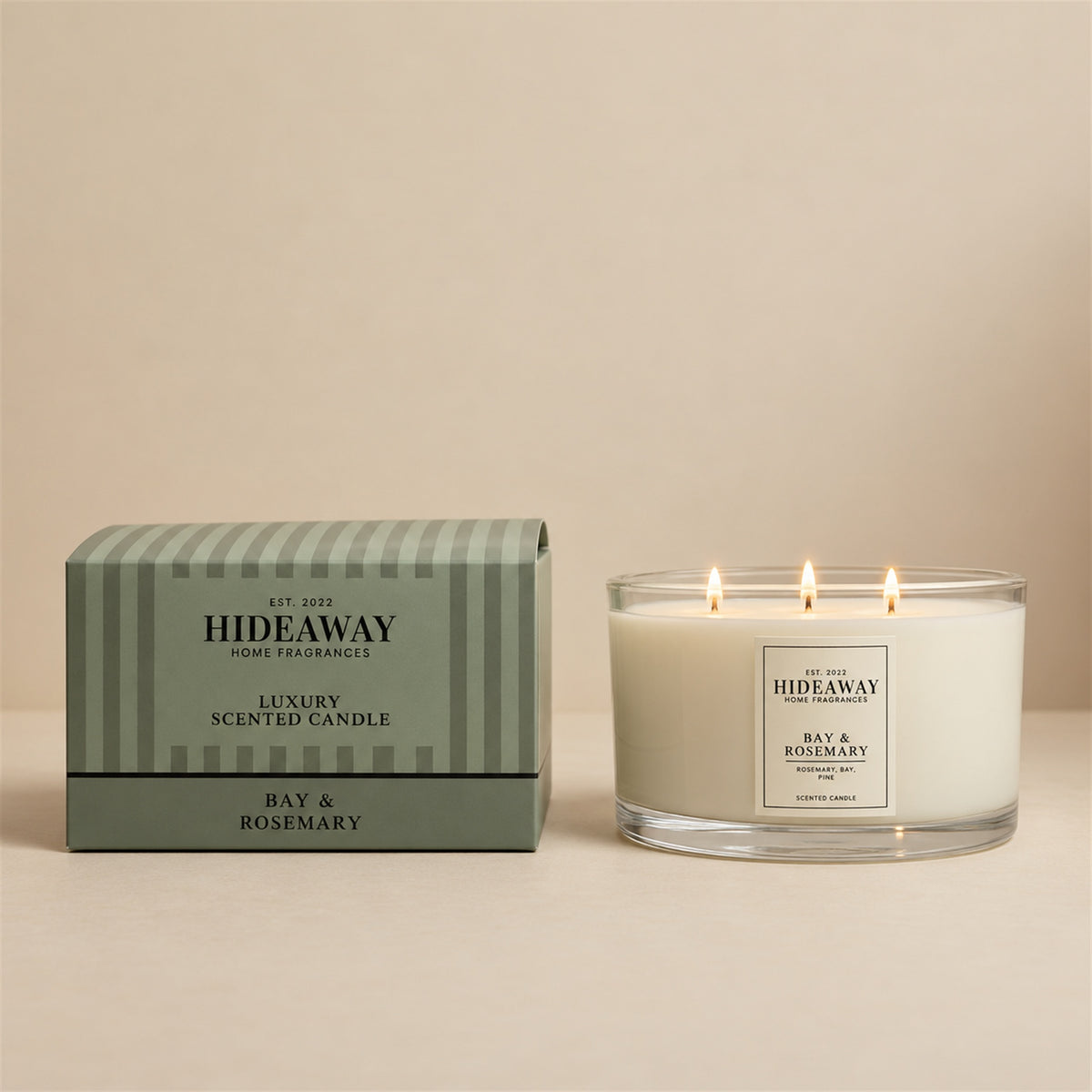 Lit triple-wick Bay & Rosemary candle glowing on a coffee table in a spacious living room, Hideaway Home Fragrances for Nostalgic, Fresh, Grounding, Clarifying