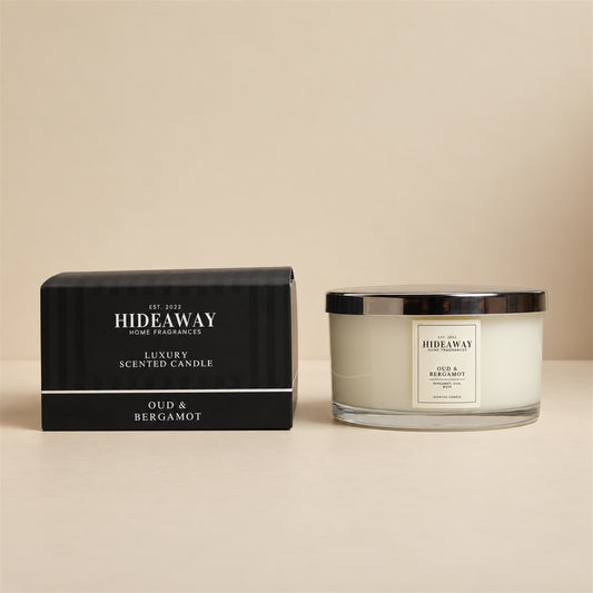 Hideaway Home Fragrances Oud and Bergamot 3 wick candle in glass jar with smoky citrus scent