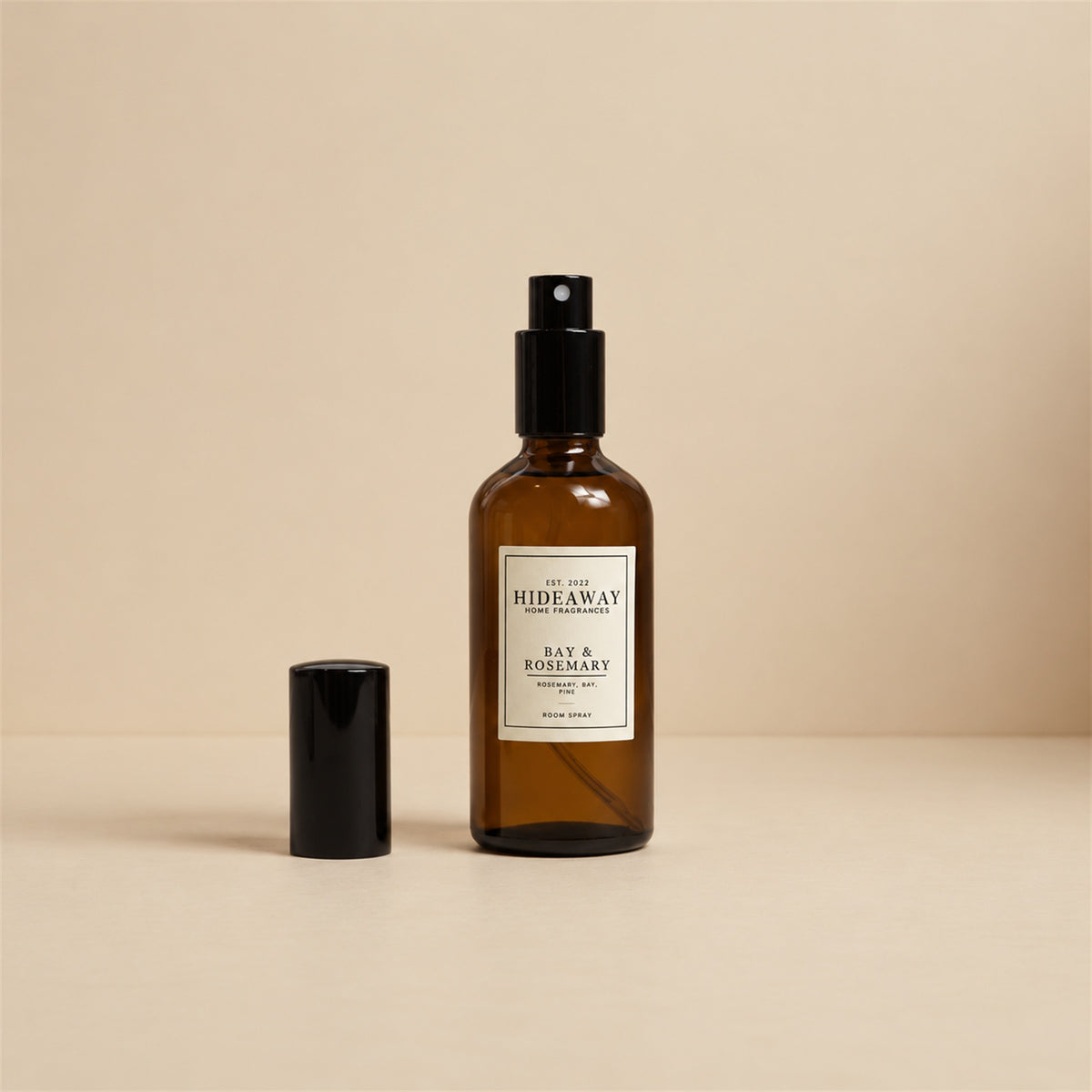 Studio shot of Hideaway Home Fragrances bay and rosemary room spray bottle on a clean white background.