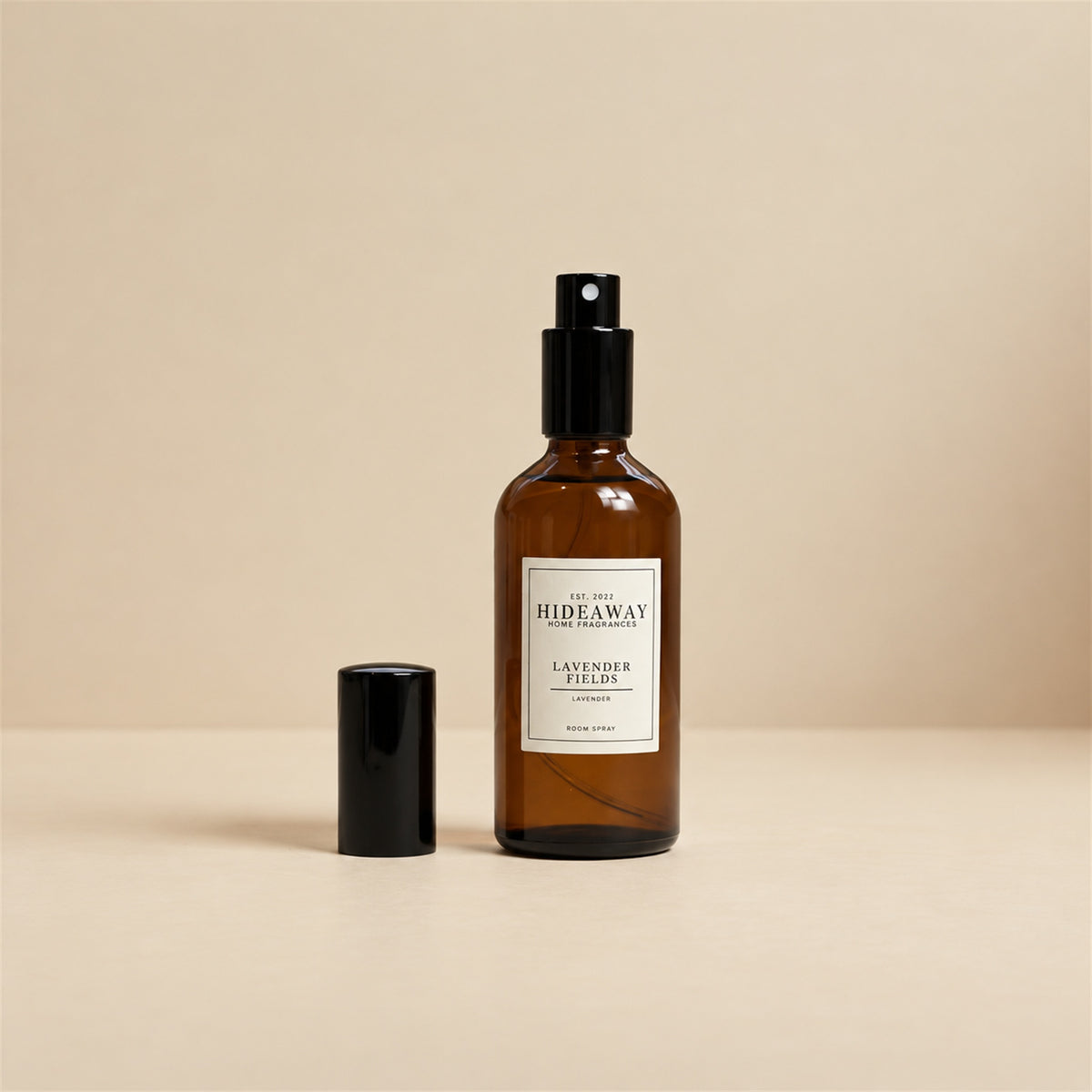Hand misting Hideaway Home Fragrances lavender fields room spray across pillows and bed linen to release calming floral aromas.