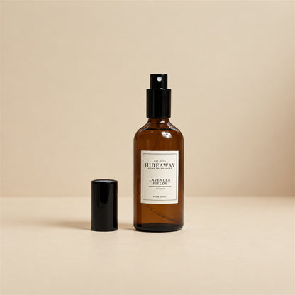Hand misting Hideaway Home Fragrances lavender fields room spray across pillows and bed linen to release calming floral aromas.