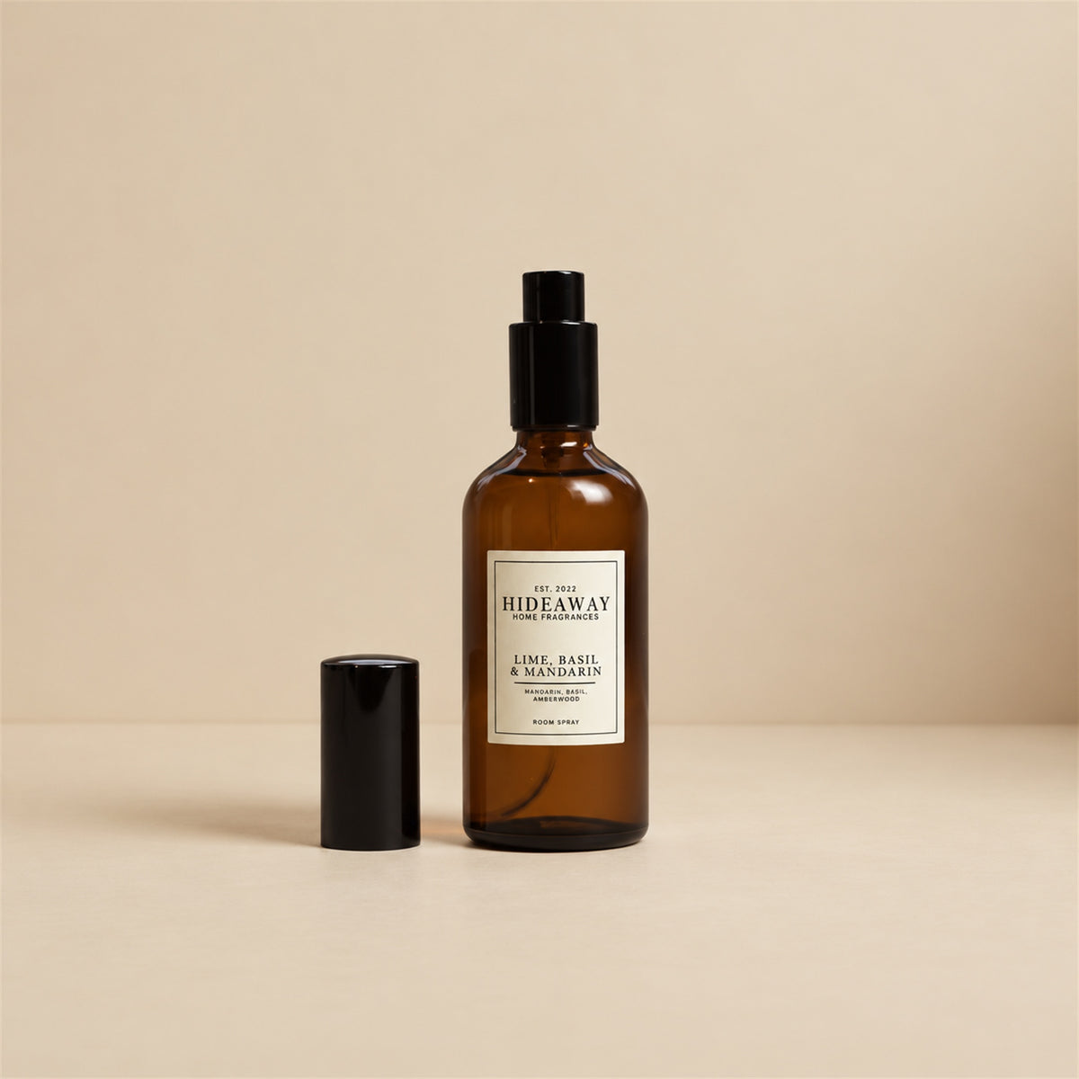 Hand misting Hideaway Home Fragrances lime basil and mandarin room spray into an airy living space to diffuse energising lemongrass and vetiver.
