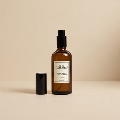Hand misting Hideaway Home Fragrances lime basil and mandarin room spray into an airy living space to diffuse energising lemongrass and vetiver.