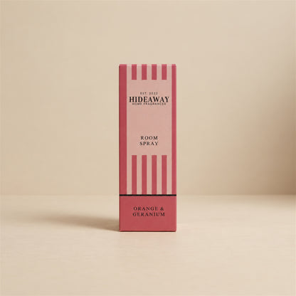 Packaged Hideaway Home Fragrances orange and geranium room spray bottle shown alongside its luxury retail gift box.