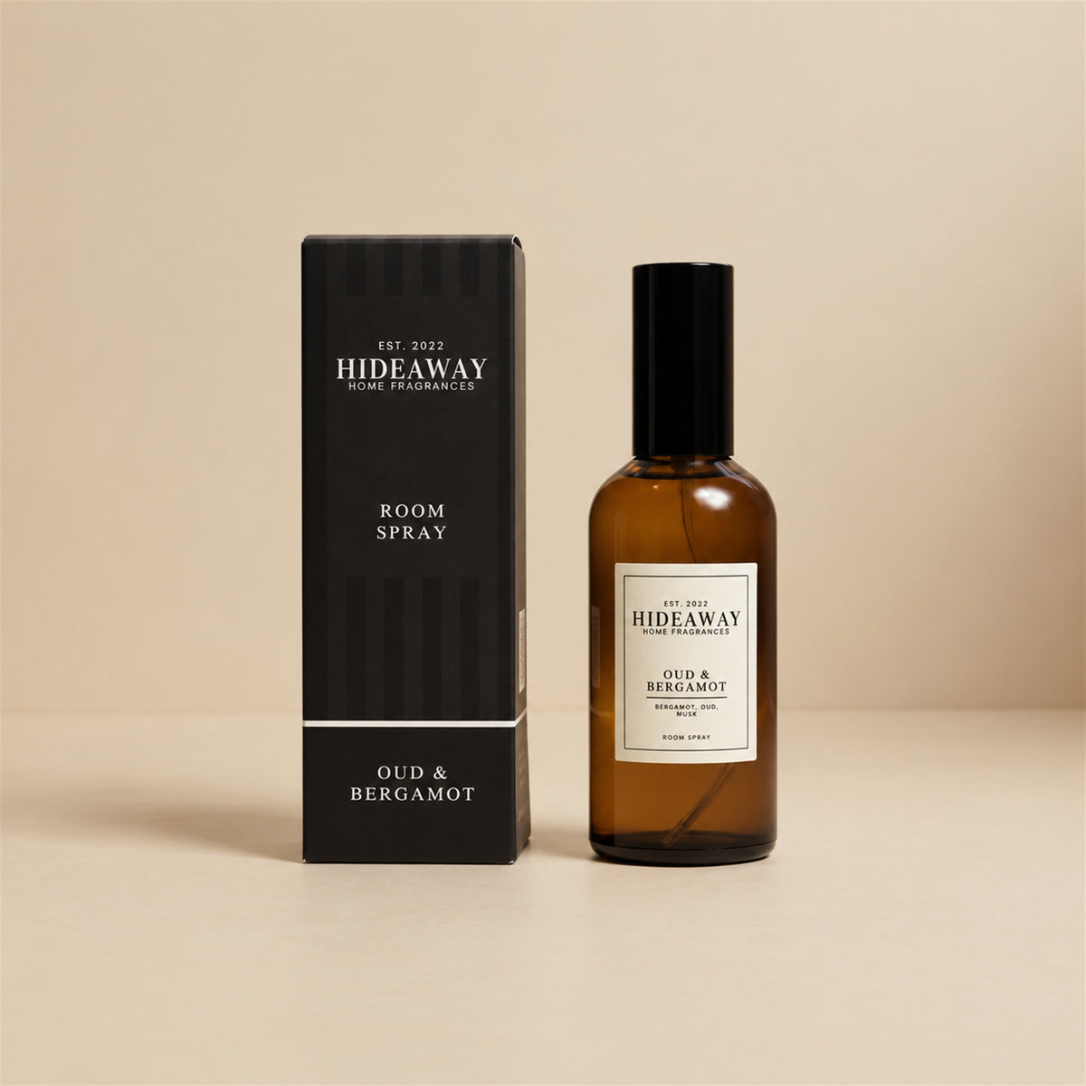 Hideaway Home Fragrances oud and bergamot room spray bottle standing against a minimal studio background.