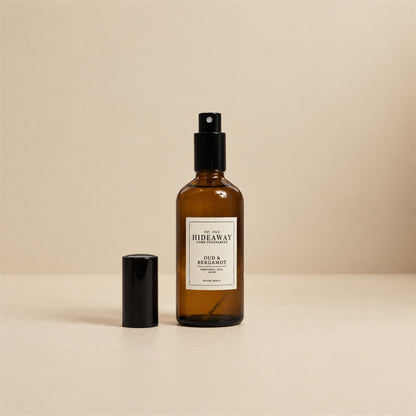 Fine mist released from the Hideaway Home Fragrances oud and bergamot room spray bottle to diffuse warm spices, musk, and precious woods into the home.