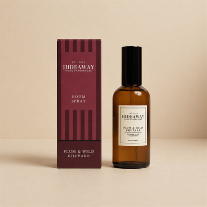 Hideaway Home Fragrances plum and wild rhubarb room spray bottle displayed on a seamless neutral studio backdrop.
