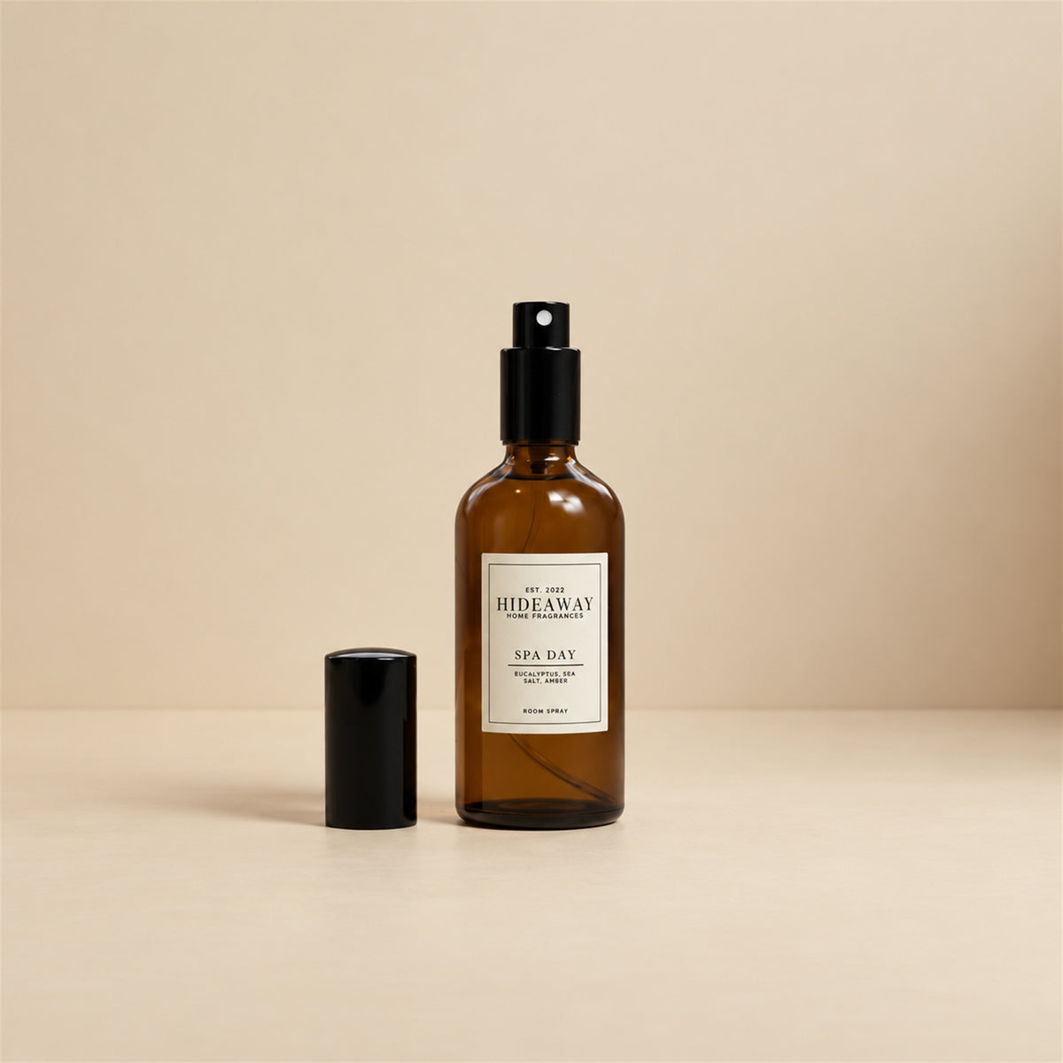 Fine mist spraying from the Hideaway Home Fragrances spa day room spray bottle to diffuse fresh sea salt, herbal thyme, and soothing floral notes.