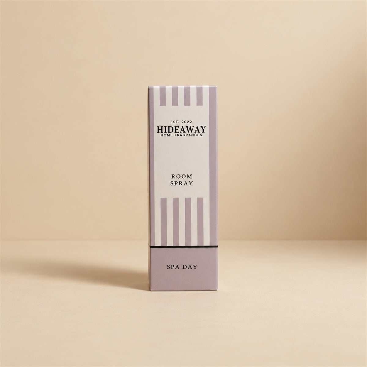 Luxury packaged gift box and matching bottle for Hideaway Home Fragrances spa day room spray highlighting clean ozone, rose, and natural wood notes.