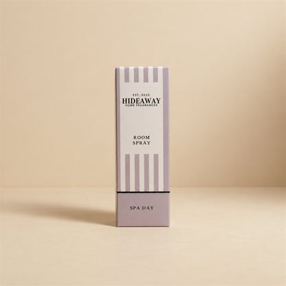 Luxury packaged gift box and matching bottle for Hideaway Home Fragrances spa day room spray highlighting clean ozone, rose, and natural wood notes.
