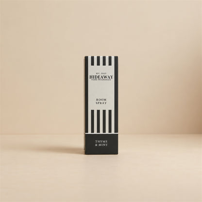 Packaged Hideaway Home Fragrances thyme and mint room spray bottle beside its luxury retail gift box highlighting herbal and citrus petitgrain notes.