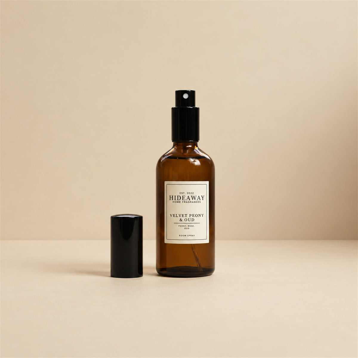 Fine mist released from the Hideaway Home Fragrances velvet peony and oud room spray bottle to diffuse warm clove, creamy milk, and vanilla notes into the room.