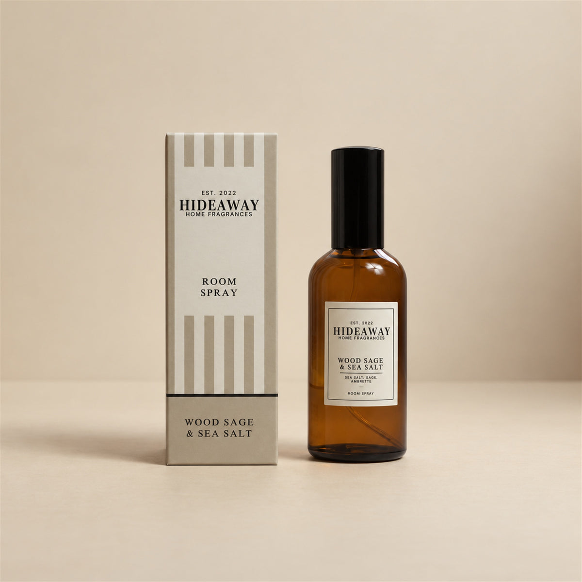 Hideaway Home Fragrances wood sage and sea salt room spray bottle displayed on a seamless white studio background.