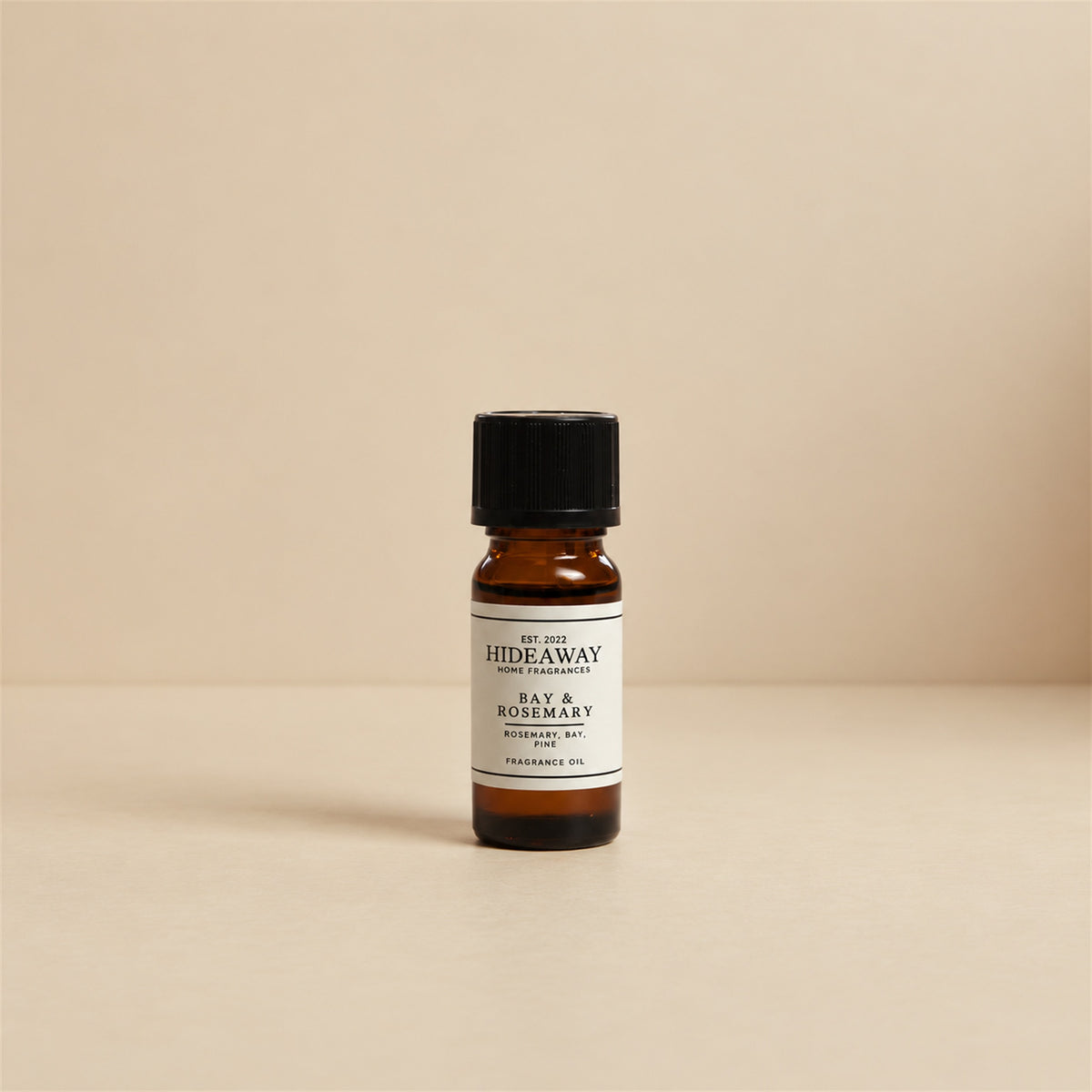 Drops of Hideaway Home Fragrances bay and rosemary fragrance oil added to an electronic diffuser alongside fresh sprigs of rosemary and lavender.