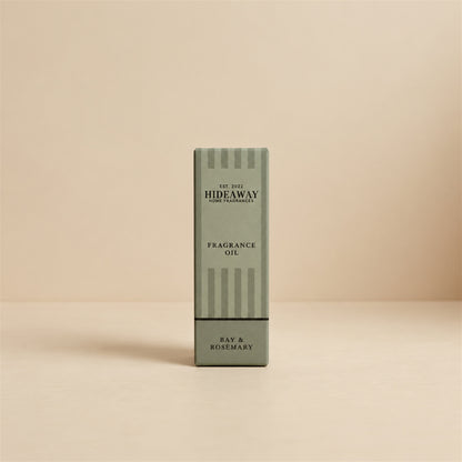 Packaged Hideaway Home Fragrances bay and rosemary fragrance oil bottle shown with its luxury retail box highlighting woody pine and musk base notes.