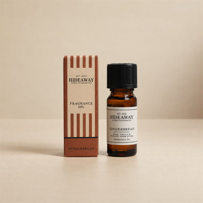 Hideaway Home Fragrances gingerbread fragrance oil bottle standing against a seamless neutral studio backdrop.