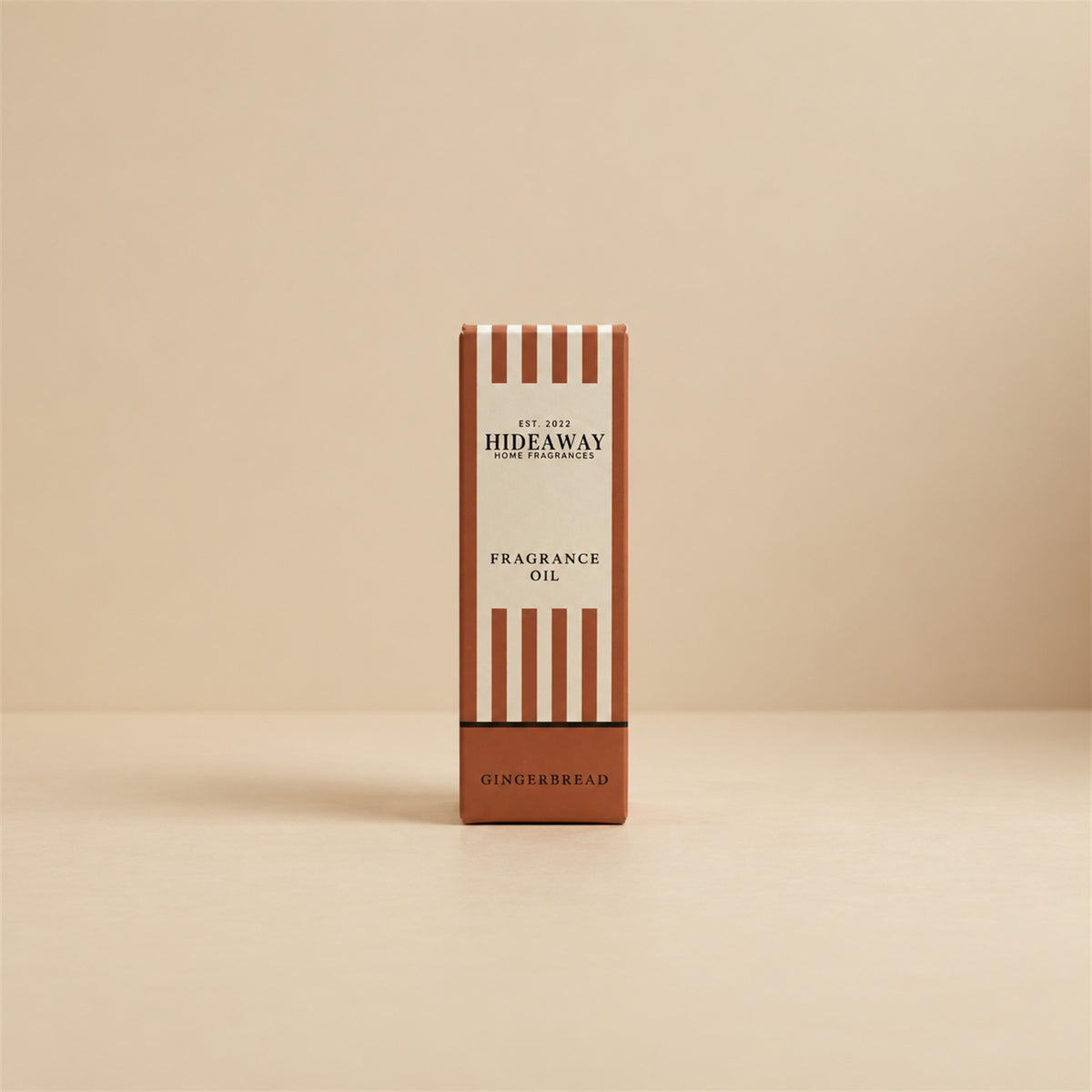 Packaged Hideaway Home Fragrances gingerbread fragrance oil bottle standing beside its luxury retail box highlighting homemade gingerbread and sweet maple syrup notes.