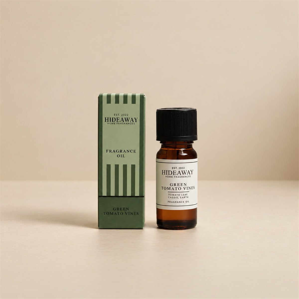 Hideaway Home Fragrances green tomato vines fragrance oil bottle standing against a seamless neutral studio backdrop.