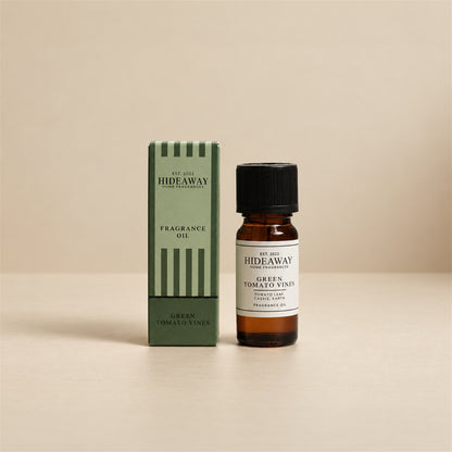 Hideaway Home Fragrances green tomato vines fragrance oil bottle standing against a seamless neutral studio backdrop.