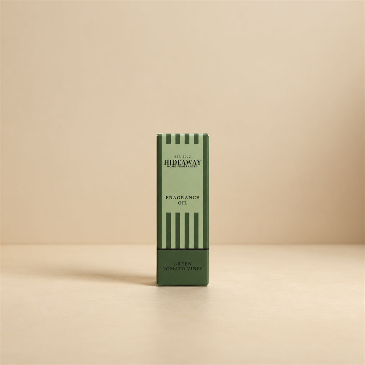 Packaged Hideaway Home Fragrances green tomato vines fragrance oil bottle shown beside its luxury gift box highlighting tagette, rosy floral, and musk notes.
