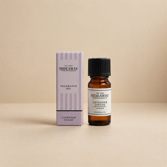 Hideaway Home Fragrances lavender fields fragrance oil bottle standing against a seamless neutral studio backdrop.